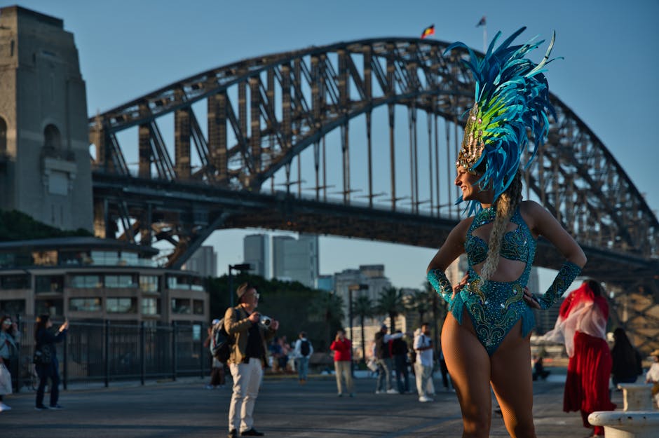 Vibrant dancer poses in elaborate costume near Sydney Harbour Bridge during a photo meetup.