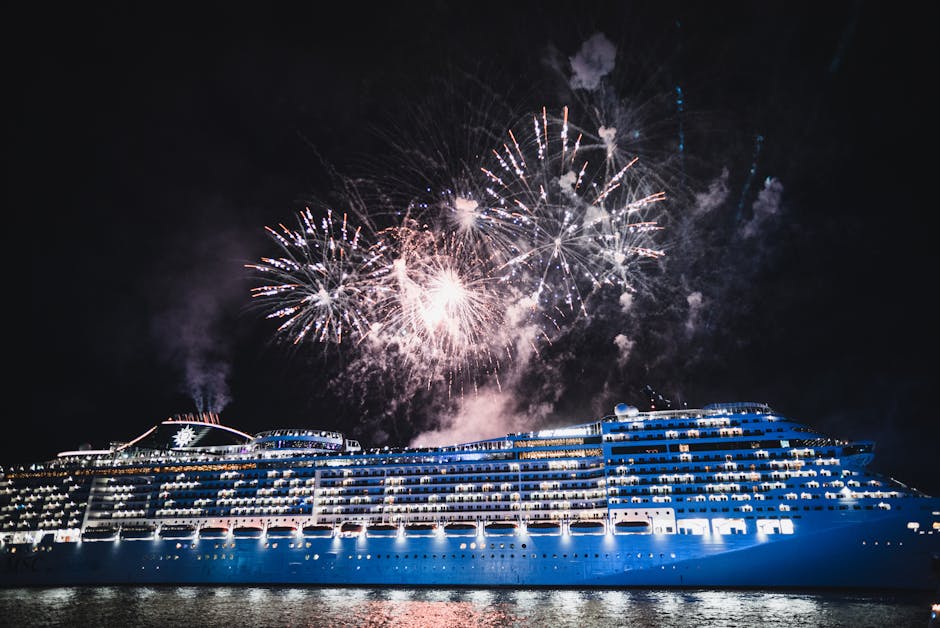 Dazzling fireworks light up the night sky above a luxurious cruise ship on the water.